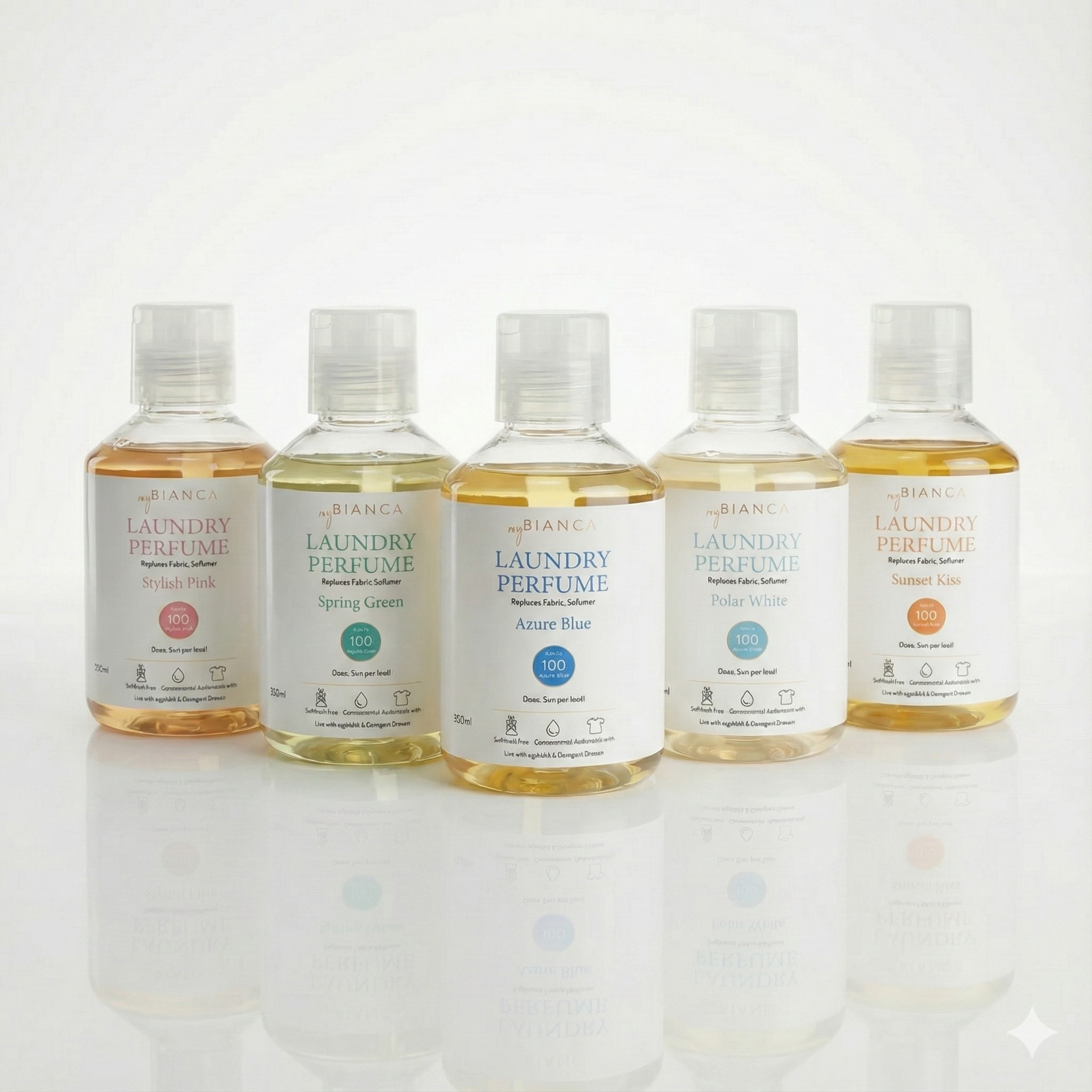 Five myBIANCA laundry perfume bottles—Stylish Pink, Spring Green, Azure Blue, Polar White, and Sunset Kiss—lined up on a reflective surface, showcasing the full fragrance collection.