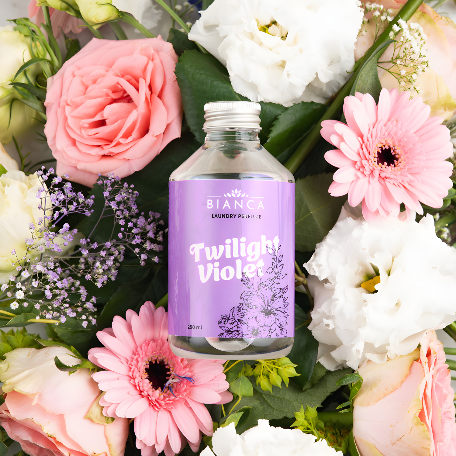 Twilight Violet laundry perfume bottle surrounded by pink and white flowers, showcasing its floral fragrance profile.