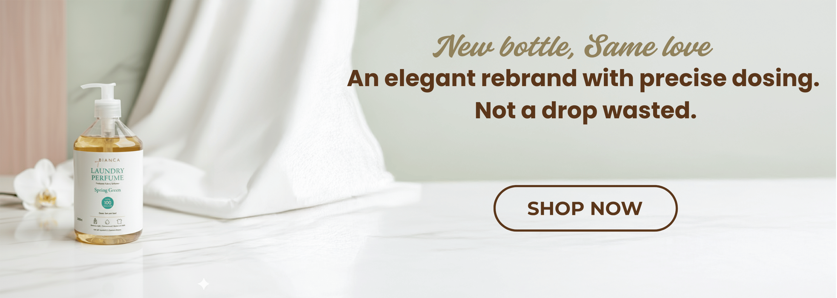 myBIANCA Spring Green Laundry Perfume bottle on a marble surface with soft fabric background